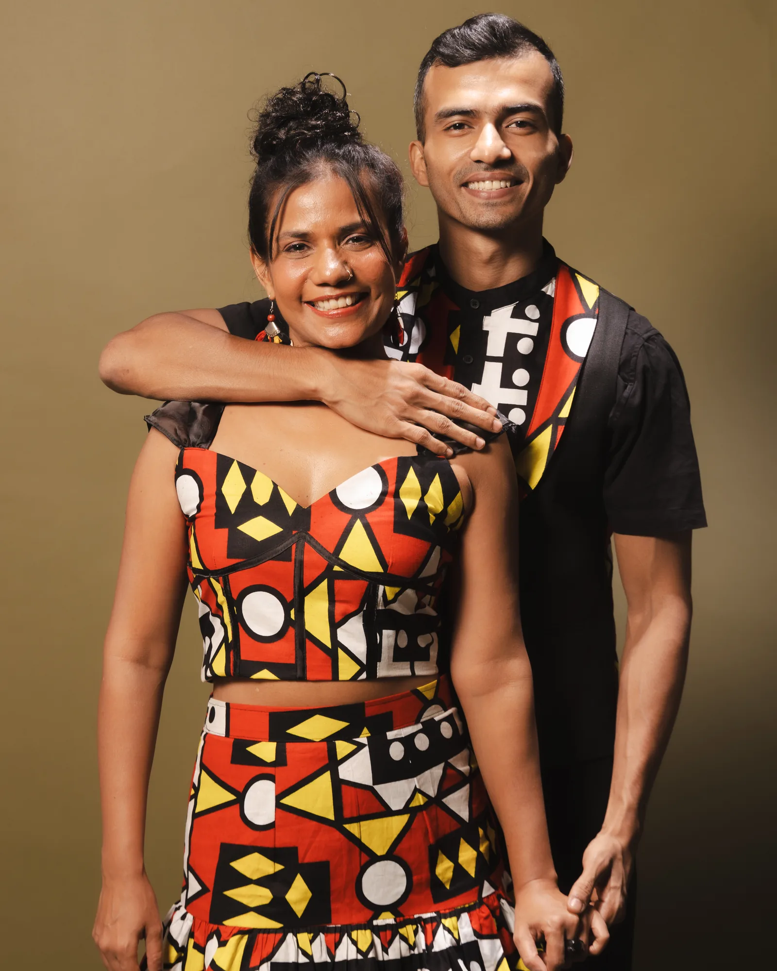 Namrata and Elvis, arms around each other, mid-smile — the duo behind this edition