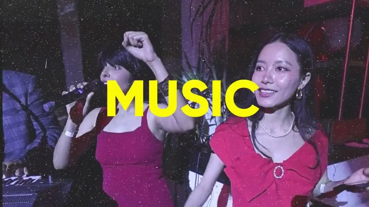 Still from The Big Howl film — a singer mid-note and a dancer in red, the word MUSIC across the frame
